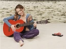 Miley Cyrus On The Beach With A Guitar