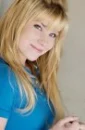Emma Degerstedt stricking a pose smiling big in Light blue