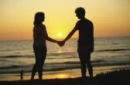 man and woman holding hands in beach