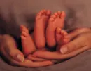 parent holding baby feet