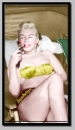 MARILYN MONROE ON THE BEACH HOLDING HER SUNGLASSES.