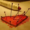 pins stuck in a heart