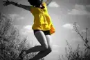 Girl Jumpinq In Yellow Dress