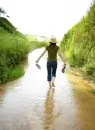 girl wading in stream