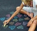 GIRL DRAWING CHALK HEARTS