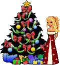 Blonde doll in a red dress standing next to a christmas tree