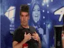Simon Cowell, rubbing his nipples