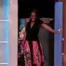 happy lady with bag coming thru door