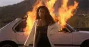 lady walking away from burning car