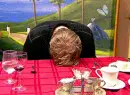 person pounding head on table
