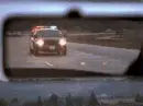 police cars with lights flashing in car mirror