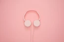 Peachy background with headphones