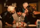 man eating, with 3 ladies yelling at him