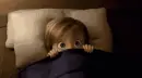 scared child in bed hiding 