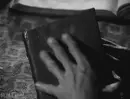 opening a book called SATAN