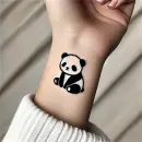 Panda tattoo on wrist