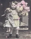 little girl with her dolly and flowers