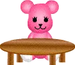 pink bear sitting at the table