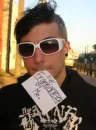 Frank Iero With A Piece Of Paper In His Mouth