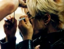Gackt paints his eyes.