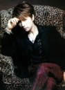 Gackt relining in a chair.