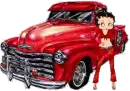Betty Boop in red standing beside old red pickup