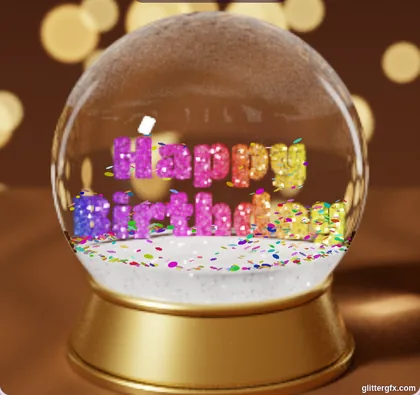 A snow globe on a gold base with Happy Birthday in rainbow glitter letters and confetti
