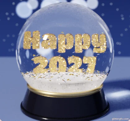 A snow globe on a black base with Happy 2027 in gold glitter letters, on a blue winter night